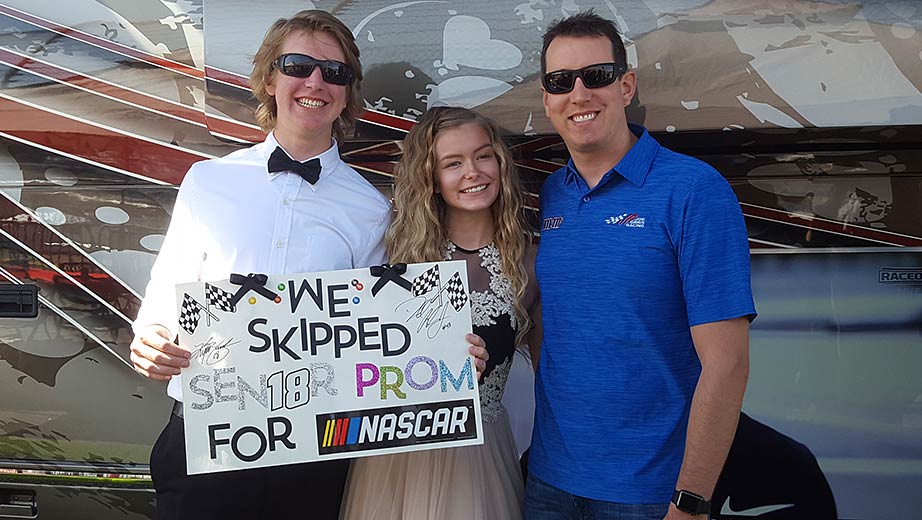 Kyle Busch greets students Isabella Smith and Sam Wheeler at Richmond Raceway.