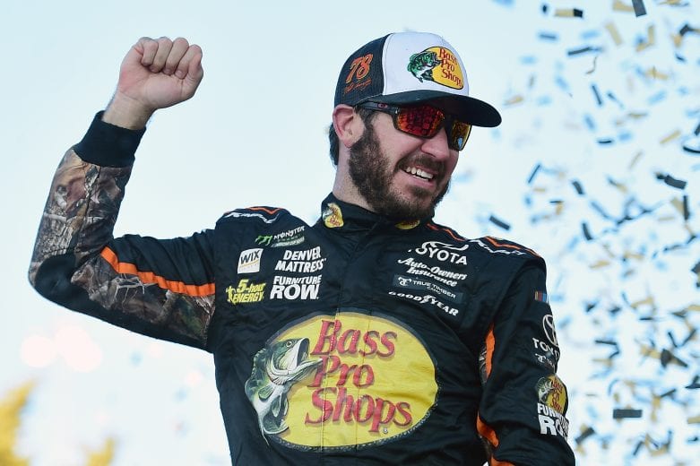 KANSAS CITY, KS - OCTOBER 22:  Martin Truex Jr., driver of the #78 Bass Pro Shops/Tracker Boats Toyota, celebrates in Victory Lane after winning the Monster Energy NASCAR Cup Series Hollywood Casino 400 at Kansas Speedway on October 22, 2017 in Kansas City, Kansas.  (Photo by Jared C. Tilton/Getty Images) | Getty Images