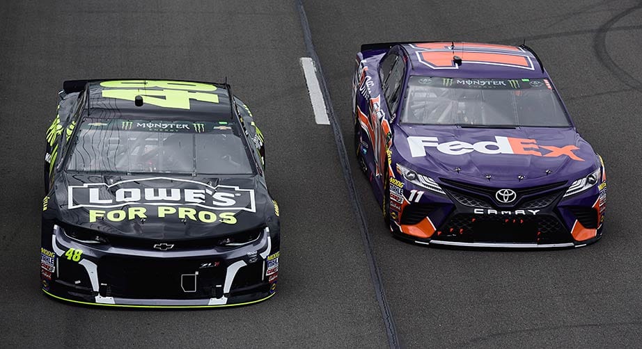 Jimmie Johnson (48) and Denny Hamlin race side by side at Pocono Raceway.