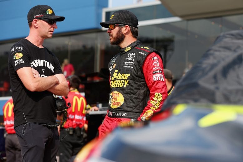 BROOKLYN, MI - AUGUST 10:  Martin Truex Jr., driver of the #78 5-hour ENERGY/Bass Pro Shops Toyota, and crew chief, Cole Pearn, stand on the grid during qualifying for the Monster Energy NASCAR Cup Series Consmers Energy 400 at Michigan International Speedway on August 10, 2018 in Brooklyn, Michigan.  (Photo by Sarah Crabill/Getty Images) | Getty Images