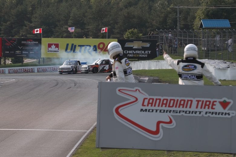 BOWMANVILLE, ON - AUGUST 26: Noah Gragson, driver of the #18 Safelite AutoGlass Toyota, takes out Todd Gilliland, driver of the #4 Frontline Toyota, on the final turn of the final lap as they both spin off the track at Canadian Tire Mosport Park on August 26, 2018 in Bowmanville, Canada. (Photo by Tom Szczerbowski/Getty Images) | Getty Images