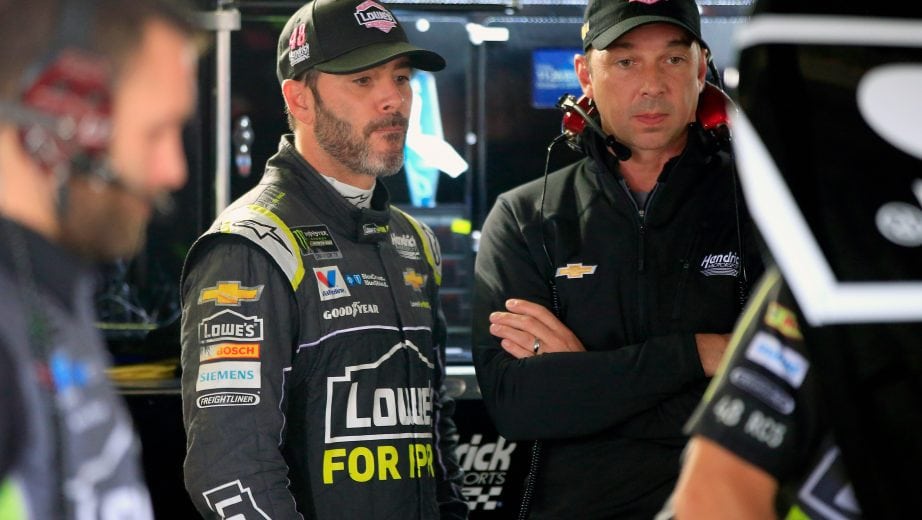 DOVER, DE - OCTOBER 05: Jimmie Johnson(L), driver of the #48 Lowe's for Pros Chevrolet, and his crew chief Chad Knaus stand in the garage area during practice for the Monster Energy NASCAR Cup Series Gander Outdoors 400 at Dover International Speedway on October 5, 2018 in Dover, Delaware. (Photo by Chris Trotman/Getty Images) | Getty Images