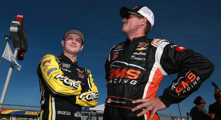 TALLADEGA, AL - OCTOBER 12:  Justin Haley, driver of the #24 Fraternal Order of Eagles Chevrolet, talks with Spencer Gallagher, driver of the #2 Allegiant Chevrolet, during qualifying for the NASCAR Camping World Truck Series Fr8Auctions 250 at Talladega Superspeedway on October 12, 2018 in Talladega, Alabama.  (Photo by Sean Gardner/Getty Images) | Getty Images