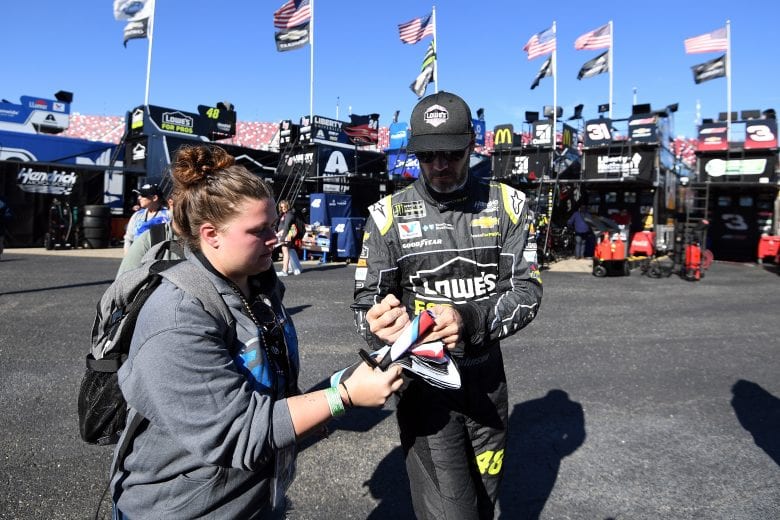 TALLADEGA, AL - OCTOBER 13:  Jimmie Johnson, driver of the #48 Lowe's for Pros Chevrolet, signs autographs in the garage area during practice for the Monster Energy NASCAR Cup Series 1000Bulbs.com 500 at Talladega Superspeedway on October 13, 2018 in Talladega, Alabama.  (Photo by Josh Hedges/Getty Images) | Getty Images