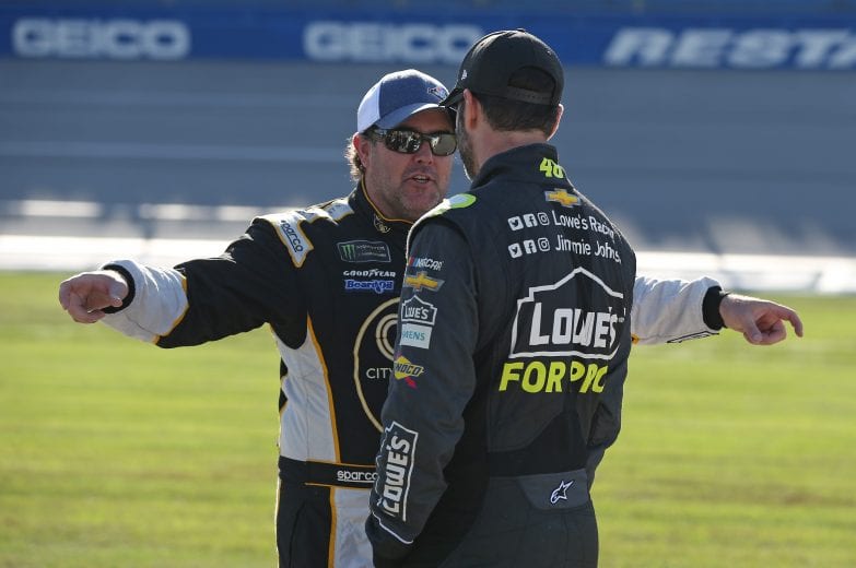 TALLADEGA, AL - OCTOBER 13:  Brendan Gaughan, driver of the #62 BeardOilDist./SouthPointHotel&CasinoChevrolet, and Jimmie Johnson, driver of the #48 Lowe's for Pros Chevrolet, talk during qualifying for the Monster Energy NASCAR Cup Series 1000Bulbs.com 500 at Talladega Superspeedway on October 13, 2018 in Talladega, Alabama.  (Photo by Matt Sullivan/Getty Images) | Getty Images