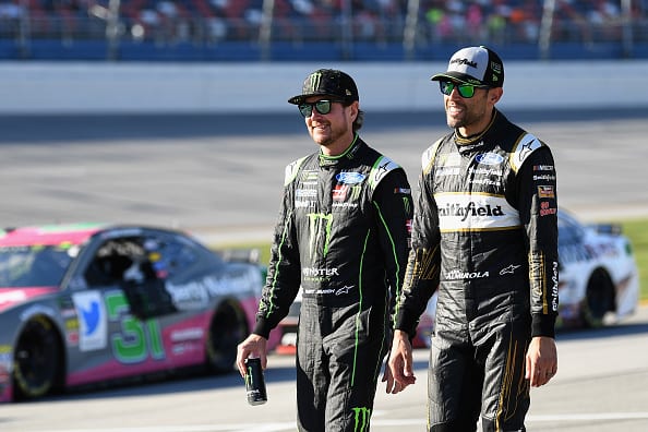 TALLADEGA, AL - OCTOBER 13:  Kurt Busch, driver of the #41 Monster Energy/Haas Automation Ford, and Aric Almirola, driver of the #10 Smithfield Bacon for Life Ford, talk during qualifying for the Monster Energy NASCAR Cup Series 1000Bulbs.com 500 at Talladega Superspeedway on October 13, 2018 in Talladega, Alabama.  (Photo by Josh Hedges/Getty Images) | Getty Images