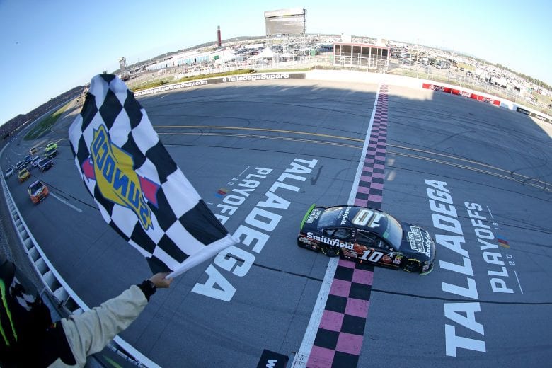 TALLADEGA, AL - OCTOBER 14:  Aric Almirola, driver of the #10 Smithfield Bacon for Life Ford, takes the checkered flag to win the Monster Energy NASCAR Cup Series 1000Bulbs.com 500 at Talladega Superspeedway on October 14, 2018 in Talladega, Alabama.  (Photo by Matt Sullivan/Getty Images) | Getty Images