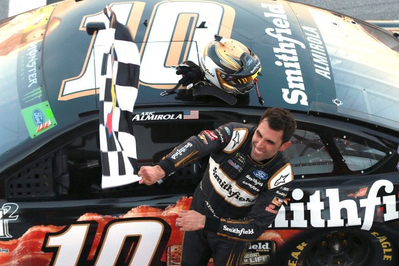 TALLADEGA, AL - OCTOBER 14:  Aric Almirola, driver of the #10 Smithfield Bacon for Life Ford, celebrates after winning the Monster Energy NASCAR Cup Series 1000Bulbs.com 500 at Talladega Superspeedway on October 14, 2018 in Talladega, Alabama.  (Photo by Matt Sullivan/Getty Images) | Getty Images
