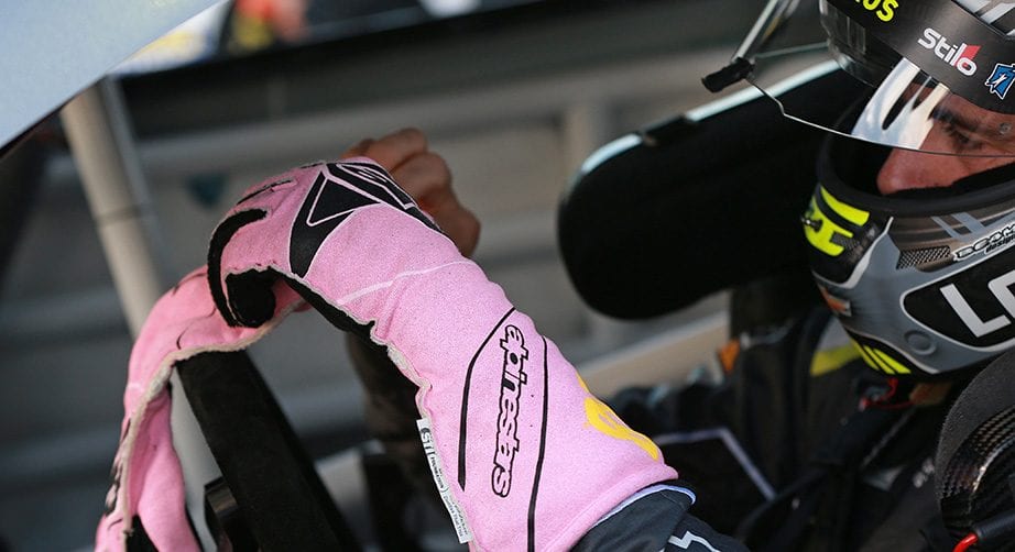 Jimmie Johnson puts on his special pink gloves at Kansas Speedway in honor of Breast Cancer Awareness Month.