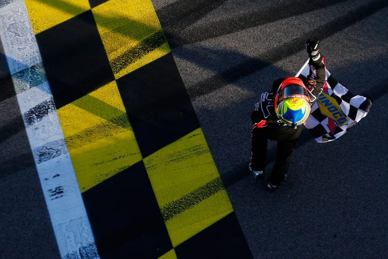 John Hunter Nemechek has the checkered flag in hand after winning at Kansas.