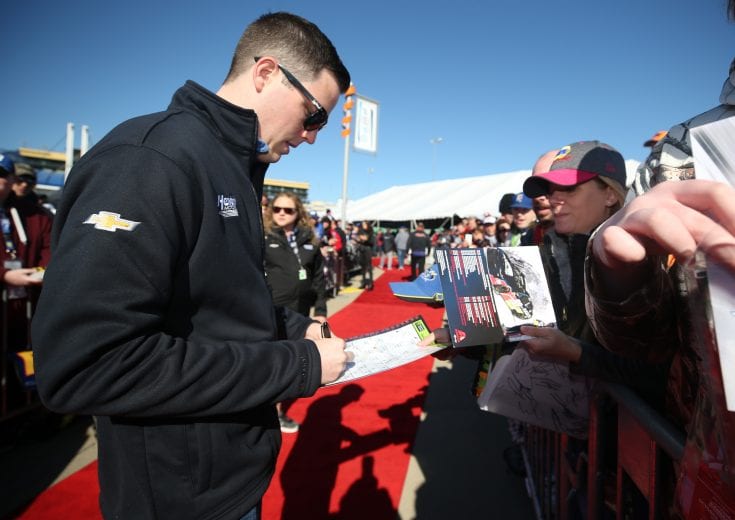 KANSAS CITY, KS - OCTOBER 21:  Alex Bowman, driver of the #88 Nationwide Chevrolet, signs autographs during pre-race festivities for the Monster Energy NASCAR Cup Series Hollywood Casino 400 at Kansas Speedway on October 21, 2018 in Kansas City, Kansas.  (Photo by Matt Sullivan/Getty Images) | Getty Images