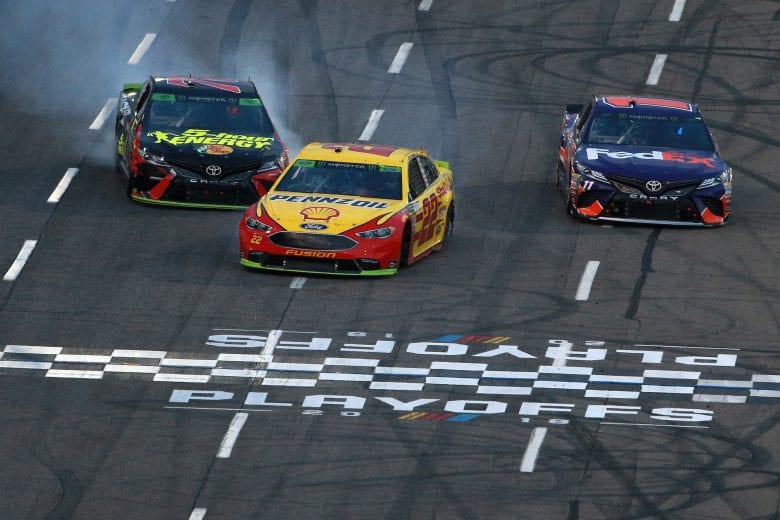 MARTINSVILLE, VA - OCTOBER 28:  Joey Logano, driver of the #22 Shell Pennzoil Ford, takes the checkered flag ahead of Denny Hamlin, driver of the #11 FedEx Freight Toyota, and Martin Truex Jr., driver of the #78 5-hour ENERGY/Bass Pro Shops Toyota, to win the Monster Energy NASCAR Cup Series First Data 500 at Martinsville Speedway on October 28, 2018 in Martinsville, Virginia.  (Photo by Sean Gardner/Getty Images) | Getty Images