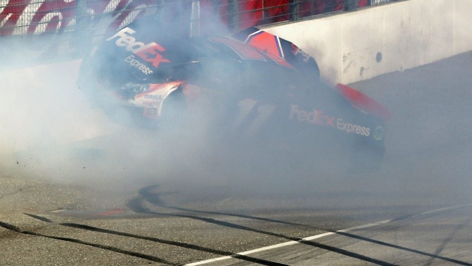 FONTANA, CA - MARCH 24: Denny Hamlin, driver of the #11 FedEx Express Toyota, hits the wall after colliding with Joey Logano (not pictured), driver of the #22 AAA Southern California Ford, on the final lap of the NASCAR Sprint Cup Series Auto Club 400 at Auto Club Speedway on March 24, 2013 in Fontana, California. (Photo by Jeff Gross/Getty Images) | Getty Images