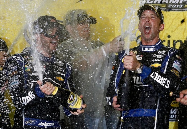 HOMESTEAD, FL - NOVEMBER 17:  Jimmie Johnson (L), driver of the #48 Lowe's/Kobalt Tools Chevrolet, poses with crew chief Chad Knaus (R) in Champions Victory Lane with their six trophies after the NASCAR Sprint Cup Series Ford EcoBoost 400 at Homestead-Miami Speedway on November 17, 2013 in Homestead, Florida.  (Photo by Jeff Zelevansky/NASCAR via Getty Images)