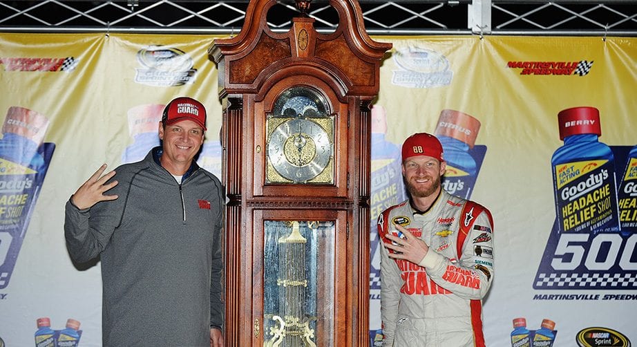 Dale Earnhardt Jr. and crew chief Steve Letarte pose with the grandfather clock after winning at Martinsville in 2014.