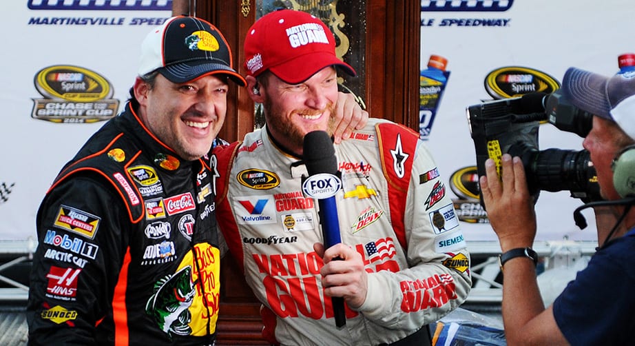 Dale Earnhardt Jr. shares a lighthearted moment with Tony Stewart while Earnhardt conducted a TV interview after winning at Martinsville in 2014.