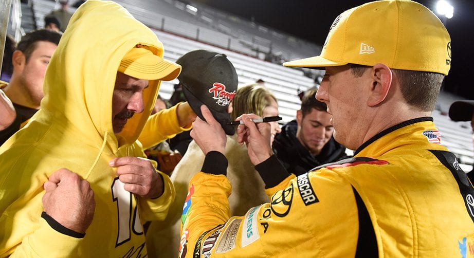 Kyle Busch signs autographs for his loyal fans after winning at Martinsville in 2017.