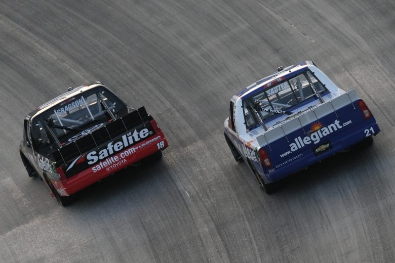 DOVER, DE - MAY 04:  Noah Gragson, driver of the #18 Safelite Toyota, and Johnny Sauter, driver of the #21 Allegiant Airlines Chevrolet, race during the NASCAR Camping World Truck Series JEGS 200 at Dover International Speedway on May 4, 2018 in Dover, Delaware.  (Photo by Jerry Markland/Getty Images) | Getty Images