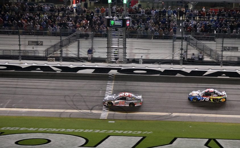 DAYTONA BEACH, FL - JULY 07:  Erik Jones, driver of the #20 buyatoyota.com Toyota, takes the checkered flag in front of Martin Truex Jr., driver of the #78 Bass Pro Shops/5-hour ENERGY Toyota, to win the Monster Energy NASCAR Cup Series Coke Zero Sugar 400 at Daytona International Speedway on July 7, 2018 in Daytona Beach, Florida.  (Photo by Jerry Markland/Getty Images) | Getty Images