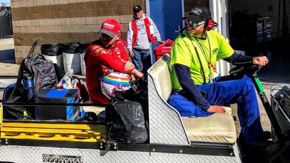 Justin Allgaier sits on a golf car after wrecking at Kansas.