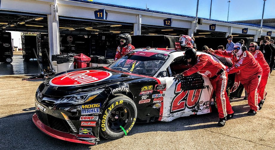 Christopher Bell's car is pushed back to the garage after a crash at Kansas.