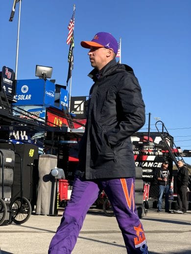Denny Hamlin walks through the garage at Kansas.