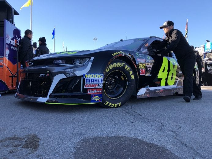 A member of the No. 48 team of Jimmie Johnson pushes the car through the garage at Kansas.