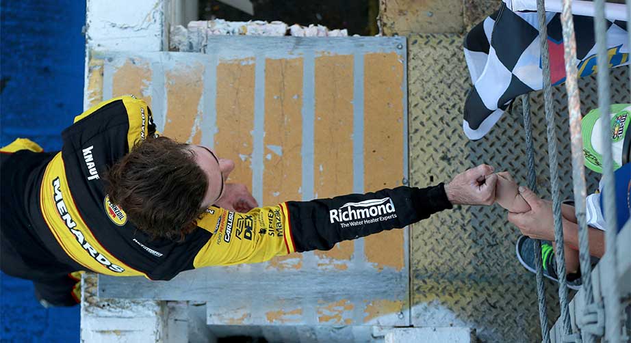 Ryan Blaney fist bumps a young fan