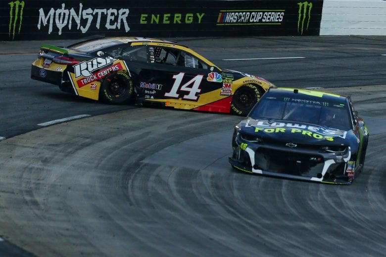 MARTINSVILLE, VA - OCTOBER 28:  Clint Bowyer, driver of the #14 Rush Truck Centers Ford, is involved in an on-track incident as Jimmie Johnson, driver of the #48 Lowe's for Pros Chevrolet, passes by during the Monster Energy NASCAR Cup Series First Data 500 at Martinsville Speedway on October 28, 2018 in Martinsville, Virginia.  (Photo by Sarah Crabill/Getty Images) | Getty Images