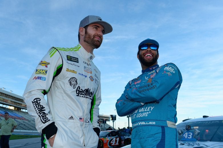 FORT WORTH, TX - NOVEMBER 02: Corey LaJoie, driver of the #72 Gas Monkey Garage Chevrolet, and Bubba Wallace, driver of the #43 NASCAR Racing Experience Chevrolet, talk on the grid during qualifying for the Monster Energy NASCAR Cup Series AAA Texas 500 at Texas Motor Speedway on November 2, 2018 in Fort Worth, Texas. (Photo by Robert Laberge/Getty Images) | Getty Images