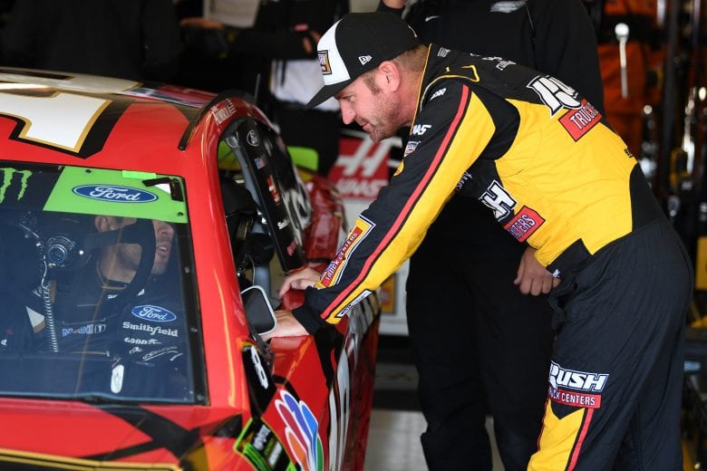 FORT WORTH, TX - NOVEMBER 03: Clint Bowyer, driver of the #14 Rush Truck Centers/Mobil Delvac 1 Ford, talks to teammate Aric Almirola, driver of the #10 Smithfield Spirals Ford, in the garage during practice for the Monster Energy NASCAR Cup Series AAA Texas 500 at Texas Motor Speedway on November 3, 2018 in Fort Worth, Texas. (Photo by Josh Hedges/Getty Images) | Getty Images