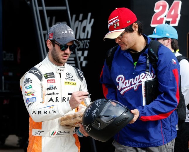 FORT WORTH, TX - NOVEMBER 03: Daniel Suarez, driver of the #19 ARRIS Toyota, signs autographs in the garage area during practice for the Monster Energy NASCAR Cup Series AAA Texas 500 at Texas Motor Speedway on November 3, 2018 in Fort Worth, Texas. (Photo by Brian Lawdermilk/Getty Images) | Getty Images