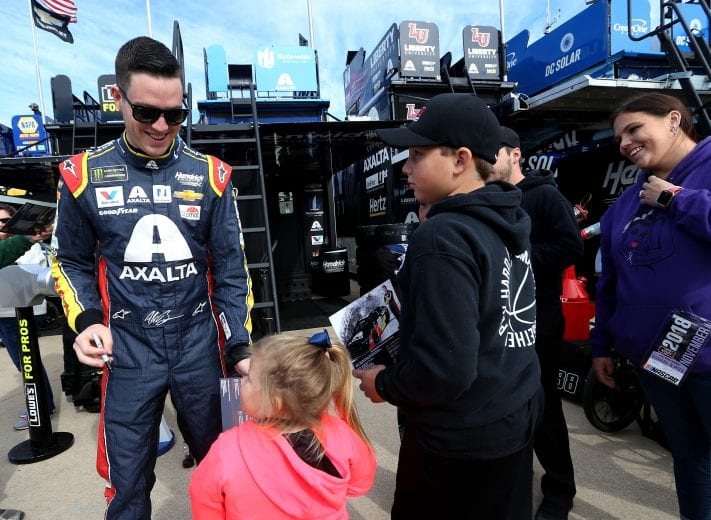 FORT WORTH, TX - NOVEMBER 03: Alex Bowman, driver of the #88 Axalta Chevrolet, greets fans in the garage area during practice for the Monster Energy NASCAR Cup Series AAA Texas 500 at Texas Motor Speedway on November 3, 2018 in Fort Worth, Texas. (Photo by Brian Lawdermilk/Getty Images) | Getty Images
