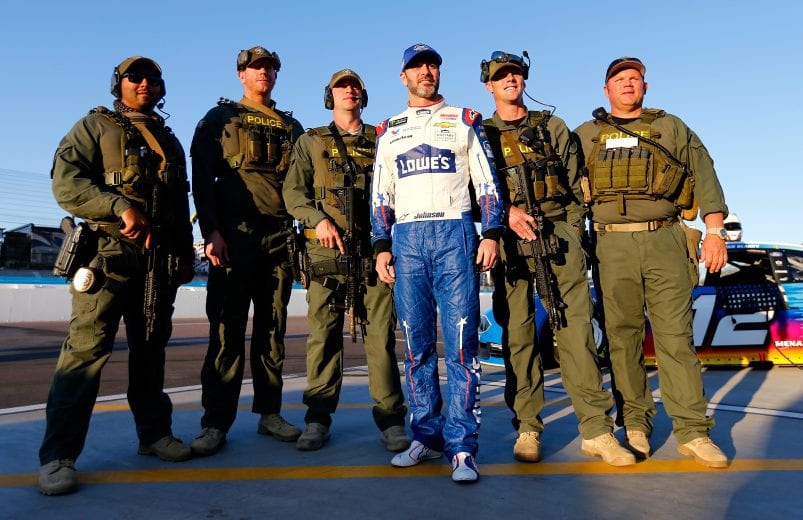 PHOENIX, AZ - NOVEMBER 09:  Jimmie Johnson, driver of the #48 Lowe's Power of Pride Chevrolet, stops to take a photo with officers prior to qualifying for the Monster Energy NASCAR Cup Series Can-Am 500 at ISM Raceway on November 9, 2018 in Phoenix, Arizona.  (Photo by Jonathan Ferrey/Getty Images) | Getty Images