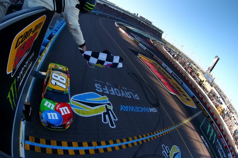 PHOENIX, AZ - NOVEMBER 11:  Kyle Busch, driver of the #18 M&M's Toyota, takes the checkered flag to win the Monster Energy NASCAR Cup Series Can-Am 500 at ISM Raceway on November 11, 2018 in Phoenix, Arizona.  (Photo by Sarah Crabill/Getty Images) | Getty Images