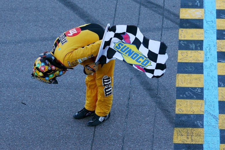 PHOENIX, AZ - NOVEMBER 11:  Kyle Busch, driver of the #18 M&M's Toyota, celebrates with the checkered flag after winning the Monster Energy NASCAR Cup Series Can-Am 500 at ISM Raceway on November 11, 2018 in Phoenix, Arizona.  (Photo by Sarah Crabill/Getty Images) | Getty Images