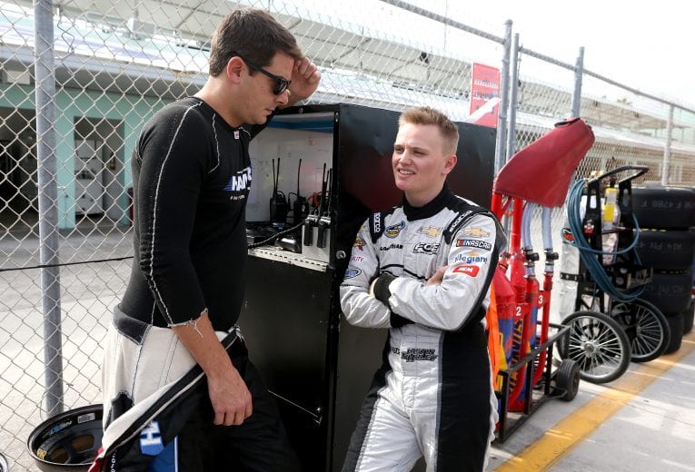 HOMESTEAD, FL - NOVEMBER 16:  Justin Haley, driver of the #24 Fraternal Order Of Eagles Chevrolet, speaks with Stewart Friesen, driver of the #52 We Build America Chevrolet, in the garage area during practice for the NASCAR Camping World Truck Series Ford EcoBoost 200 at Homestead-Miami Speedway on November 16, 2018 in Homestead, Florida.  (Photo by Brian Lawdermilk/Getty Images) | Getty Images