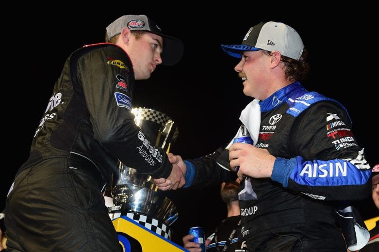 HOMESTEAD, FL - NOVEMBER 16:  Brett Moffitt, driver of the #16 AISIN Group Toyota, shakes hands with Noah Gragson, driver of the #18 Safelite AutoGlass Toyota, after winning the NASCAR Camping World Truck Series Ford EcoBoost 200 and the NASCAR Camping World Truck Series Championship at Homestead-Miami Speedway on November 16, 2018 in Homestead, Florida.  (Photo by Jared C. Tilton/Getty Images) | Getty Images
