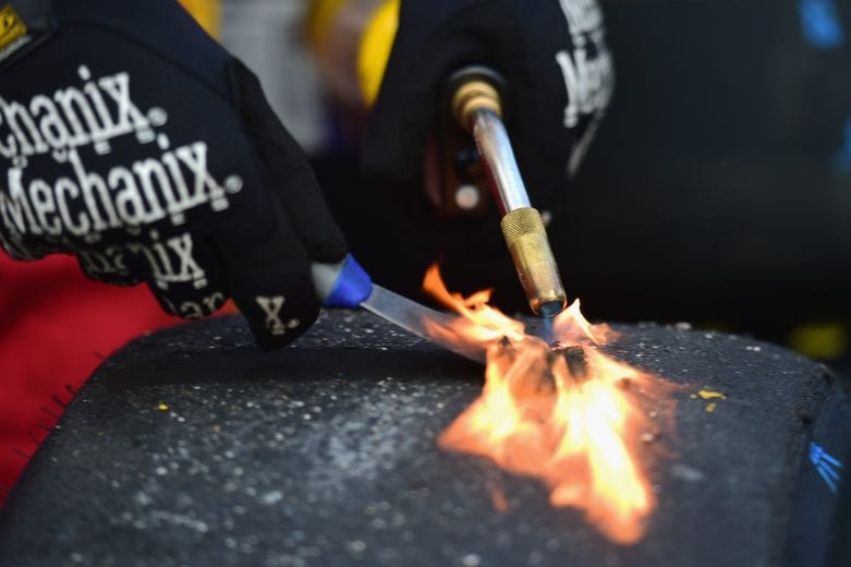 HOMESTEAD, FL - NOVEMBER 18:  A crew members works on a tire during the Monster Energy NASCAR Cup Series Ford EcoBoost 400 at Homestead-Miami Speedway on November 18, 2018 in Homestead, Florida.  (Photo by Jared C. Tilton/Getty Images) | Getty Images