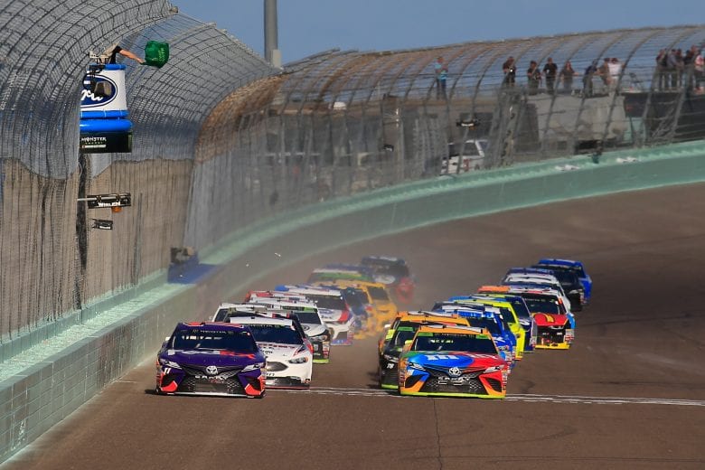 HOMESTEAD, FL - NOVEMBER 18:  Denny Hamlin, driver of the #11 FedEx Express Toyota, and Kyle Busch, driver of the #18 M&M's Toyota, take the green flag to start the Monster Energy NASCAR Cup Series Ford EcoBoost 400 at Homestead-Miami Speedway on November 18, 2018 in Homestead, Florida.  (Photo by Chris Trotman/Getty Images) | Getty Images