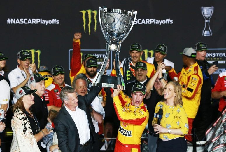 HOMESTEAD, FL - NOVEMBER 18:  Joey Logano, driver of the #22 Shell Pennzoil Ford, celebrates with the trophy in victory lane after winning the Monster Energy NASCAR Cup Series Ford EcoBoost 400 and the Monster Energy NASCAR Cup Series Championship at Homestead-Miami Speedway on November 18, 2018 in Homestead, Florida.  (Photo by Sean Gardner/Getty Images) | Getty Images
