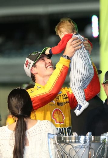 HOMESTEAD, FL - NOVEMBER 18:  Joey Logano, driver of the #22 Shell Pennzoil Ford, celebrates with his wife, Brittany, and son, Hudson, after winning the Monster Energy NASCAR Cup Series Ford EcoBoost 400 at Homestead-Miami Speedway on November 18, 2018 in Homestead, Florida.  (Photo by Matt Sullivan/Getty Images) | Getty Images