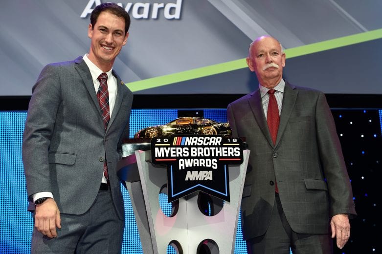 Joey Logano receives the Goodyear Gold Car at the NMPA Myers Brothers Awards ceremony in Las Vegas.
