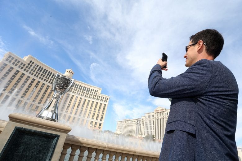 Joey Logano takes a picture of his championship trophy at the Bellagio.