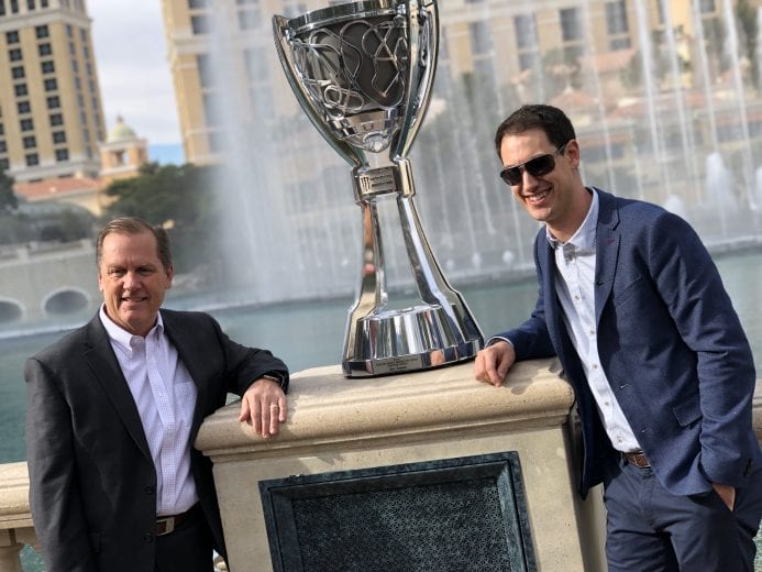 Joey Logano and crew chief Todd Gordon pose with the Monster Energy Series championship trophy at the Bellagio in Las Vegas.