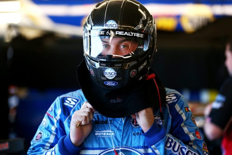 Kevin Harvick puts on his helmet in the garage at ISM Raceway.