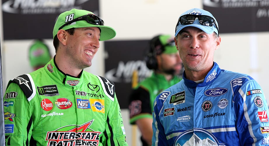 BROOKLYN, MI - AUGUST 11:  Kyle Busch, driver of the #18 Interstate Batteries Toyota, and Kevin Harvick, driver of the #4 Busch Light/Mobil 1 Ford, talk in the garage before practice for the Monster Energy NASCAR Cup Series Consmers Energy 400 at Michigan International Speedway on August 11, 2018 in Brooklyn, Michigan.  (Photo by Jerry Markland/Getty Images) | Getty Images