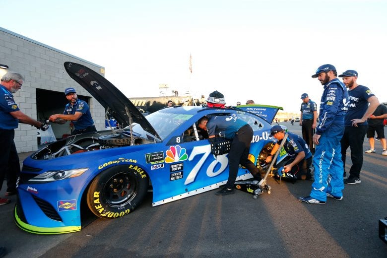 Martin Truex looks on as the No. 78 goes through inspection at ISM Raceway.