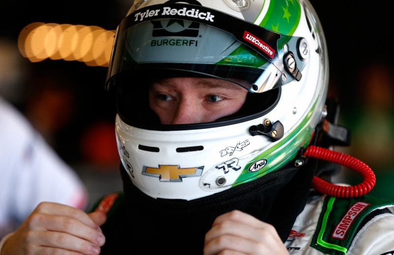 Tyler Reddick gets ready to strap in his race car.