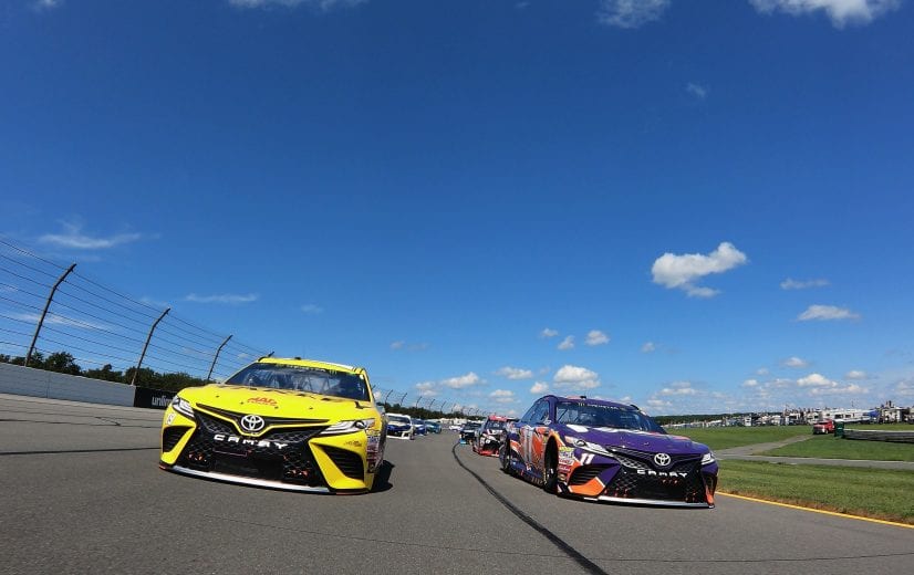 LONG POND, PA - JULY 29:  Daniel Suarez, driver of the #19 Stanley Toyota, and Denny Hamlin, driver of the #11 FedEx Express Toyota, lead the field prior to the start of the Monster Energy NASCAR Cup Series Gander Outdoors 400 at Pocono Raceway on July 29, 2018 in Long Pond, Pennsylvania.  (Photo by Jared C. Tilton/Getty Images) | Getty Images